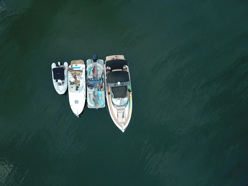 Slide: The Image of Four boats, including a Carver 36 Mariner, on calm water. - 24