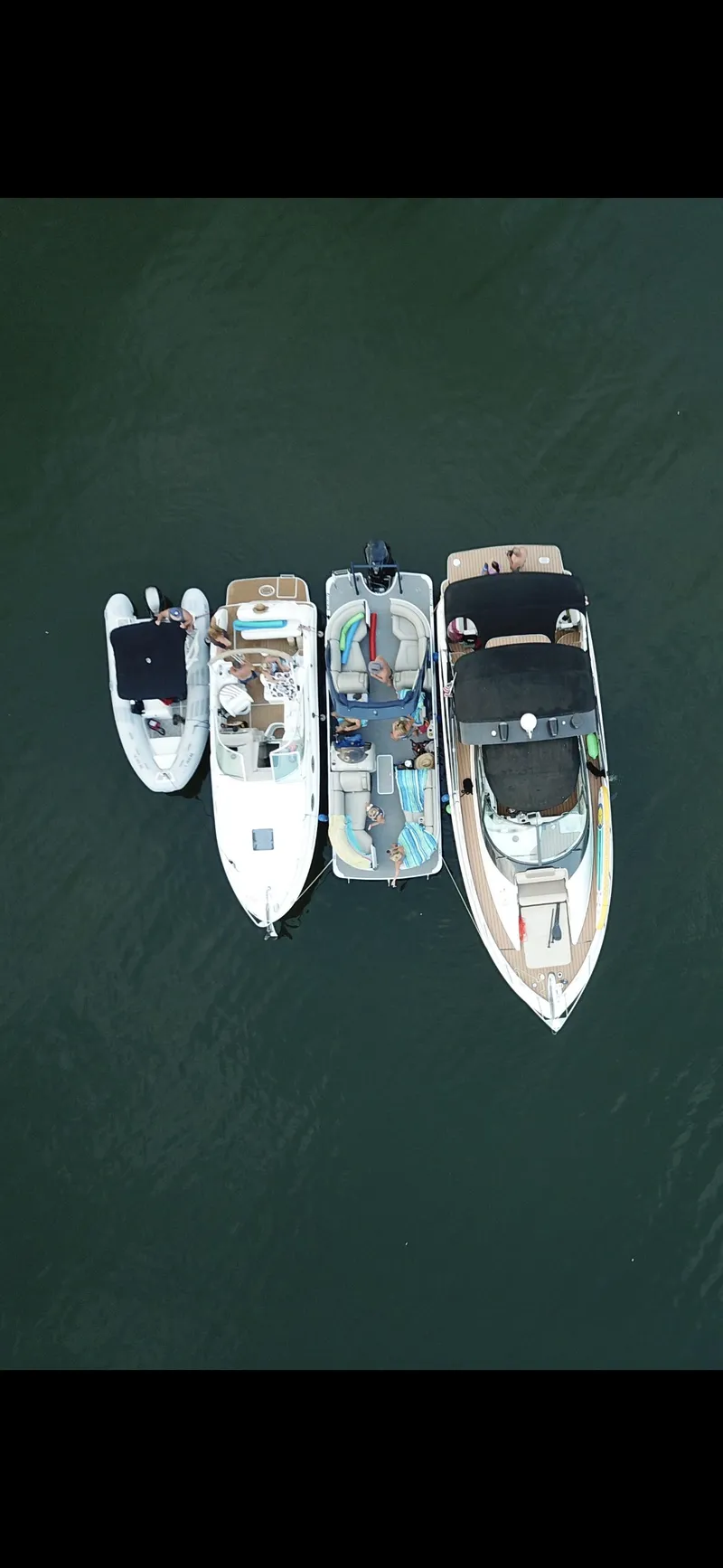 Slide: The Image of Aerial view of four boats, including a Carver 36 Mariner, on the water. - 28