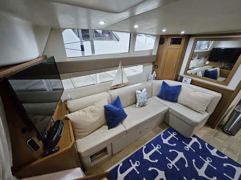 Slide: The Image of Interior of 2012 Carver 36 Mariner with cozy sofa and nautical decor. - 29