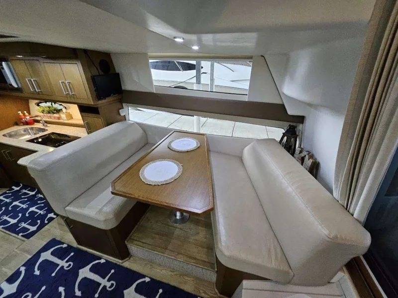 Slide: The Image of Interior of 2012 Carver 36 Mariner with dining area and kitchen. - 31