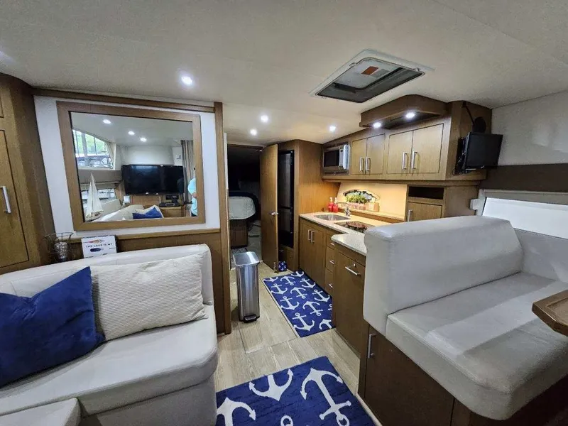 Slide: The Image of Interior of 2012 Carver 36 Mariner with modern kitchen and cozy living area. - 33