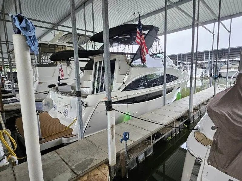 Slide: The Image of 2012 Carver 36 Mariner docked with American flag. - 38