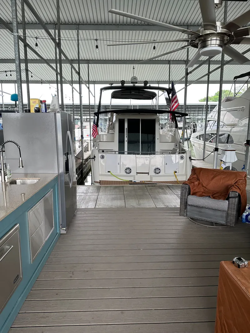 Slide: The Image of Carver 36 Mariner 2012 in covered dock area with seating. - 4