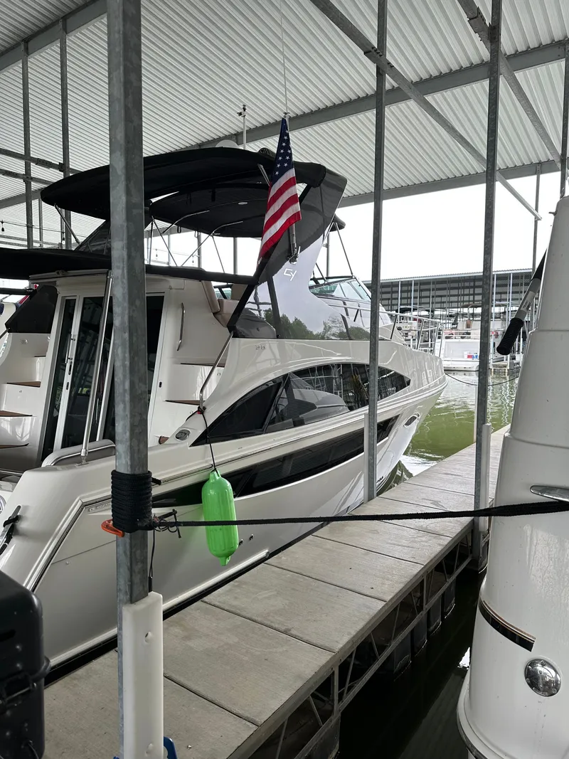 Slide: The Image of Carver 36 Mariner 2012 yacht docked with American flag. - 5