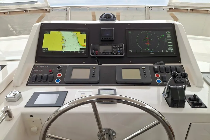 Slide: The Image of Pilothouse dashboard of 2004 Ocean Alexander 64 with navigation screens and controls. - 23