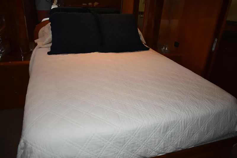 Slide: The Image of Luxurious bedroom interior of 2004 Ocean Alexander 64 Pilothouse yacht with elegant bedding. - 67