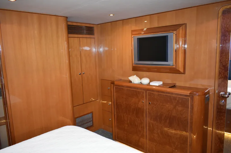 Slide: The Image of Luxurious wooden interior of 2004 Ocean Alexander 64 Pilothouse yacht cabin with TV. - 55
