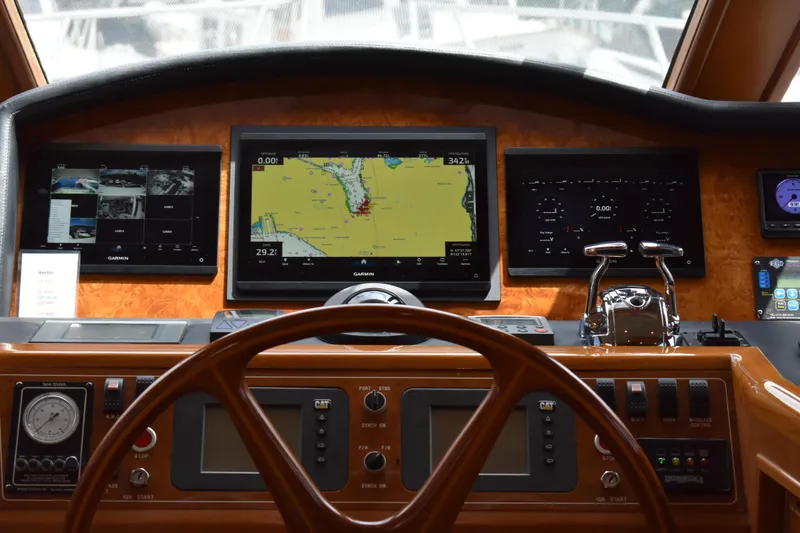 Slide: The Image of Pilothouse of 2004 Ocean Alexander 64, featuring navigation screens and controls. - 37