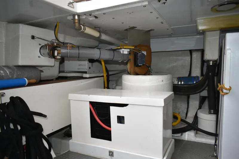 Slide: The Image of Engine room of 2004 Ocean Alexander 64 Pilothouse yacht, showcasing mechanical equipment. - 86