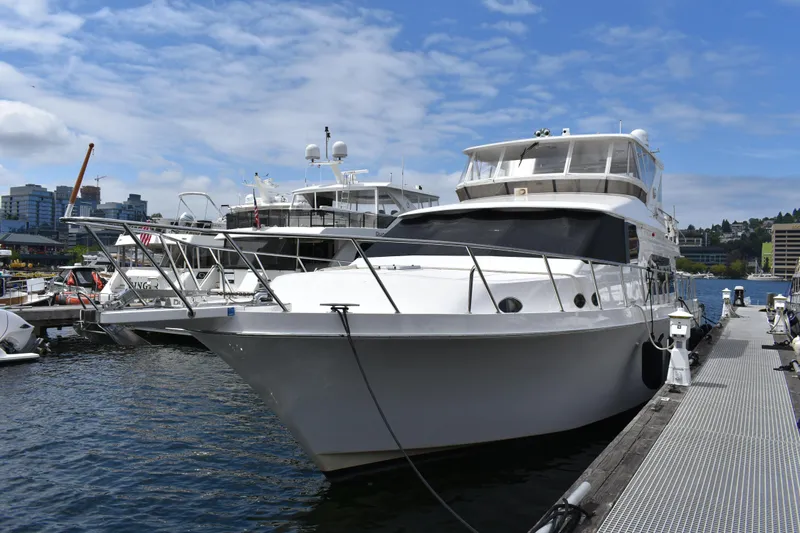 Slide: The Image of Luxury 2004 Ocean Alexander 64 Pilothouse yacht docked at marina. - 2