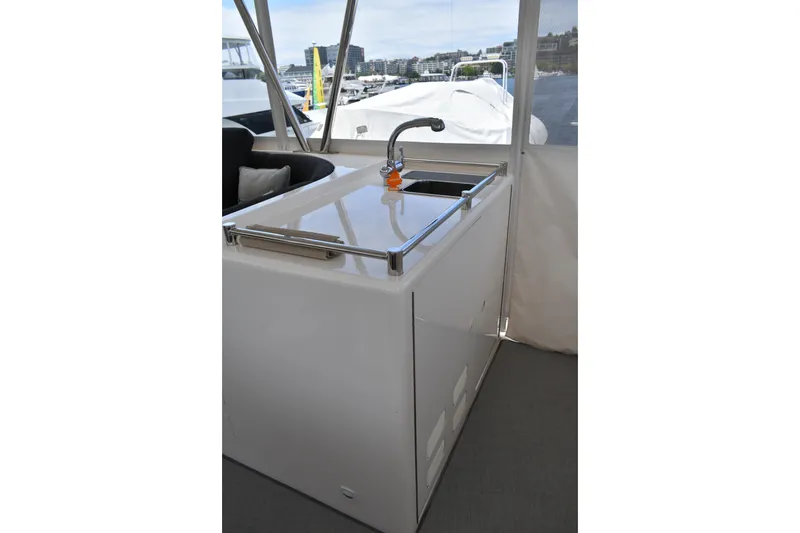 Slide: The Image of Outdoor sink area on 2004 Ocean Alexander 64 Pilothouse yacht, with marina view. - 27