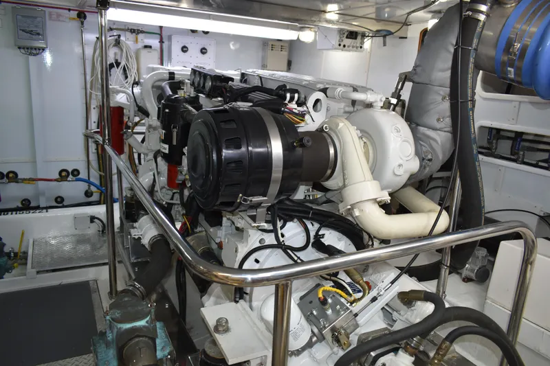 Slide: The Image of Engine room of 2004 Ocean Alexander 64 Pilothouse yacht, showcasing detailed machinery. - 77