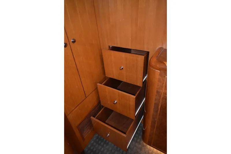 Slide: The Image of Open wooden drawers inside a 2004 Ocean Alexander 64 Pilothouse yacht interior. - 58