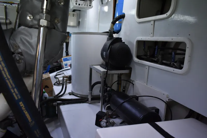 Slide: The Image of Engine room of 2004 Ocean Alexander 64 Pilothouse yacht, showcasing mechanical components. - 79