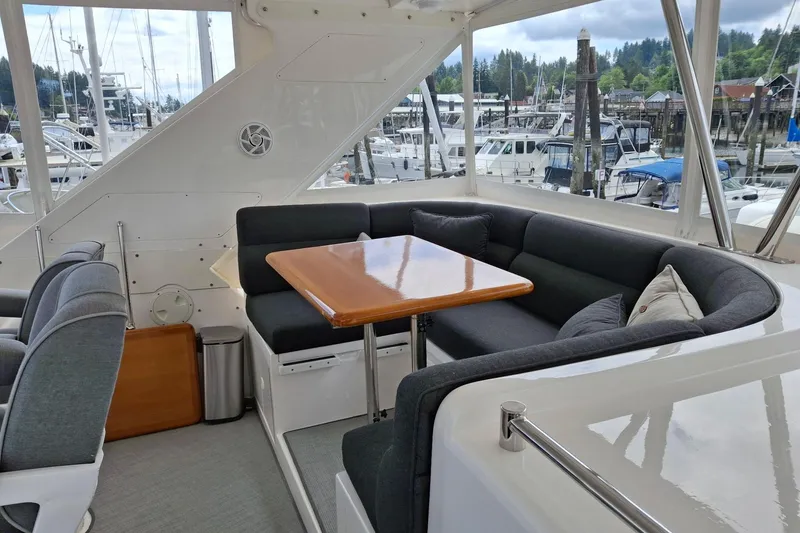 Slide: The Image of Luxurious seating area on 2004 Ocean Alexander 64 Pilothouse yacht, docked at marina. - 24
