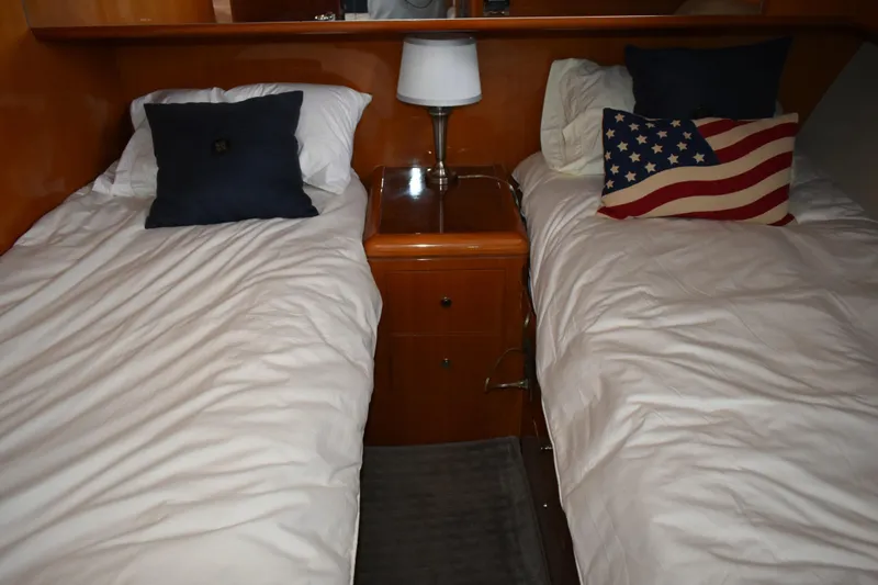 Slide: The Image of Twin beds in 2004 Ocean Alexander 64 Pilothouse cabin with American flag pillow. - 63