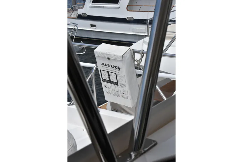 Slide: The Image of Lifesling on 2004 Ocean Alexander 64 Pilothouse yacht, docked with safety equipment visible. - 30