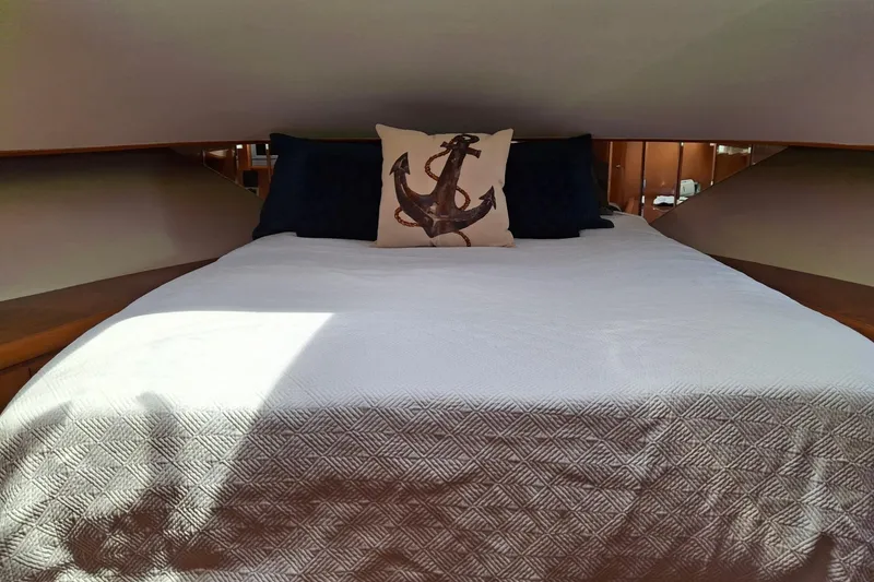 Slide: The Image of Luxurious bedroom in 2004 Ocean Alexander 64 Pilothouse yacht with anchor-themed decor. - 68