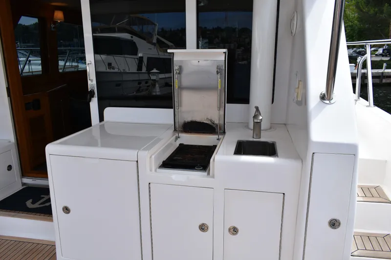 Slide: The Image of Outdoor kitchen area on a 2004 Ocean Alexander 64 Pilothouse yacht. - 18