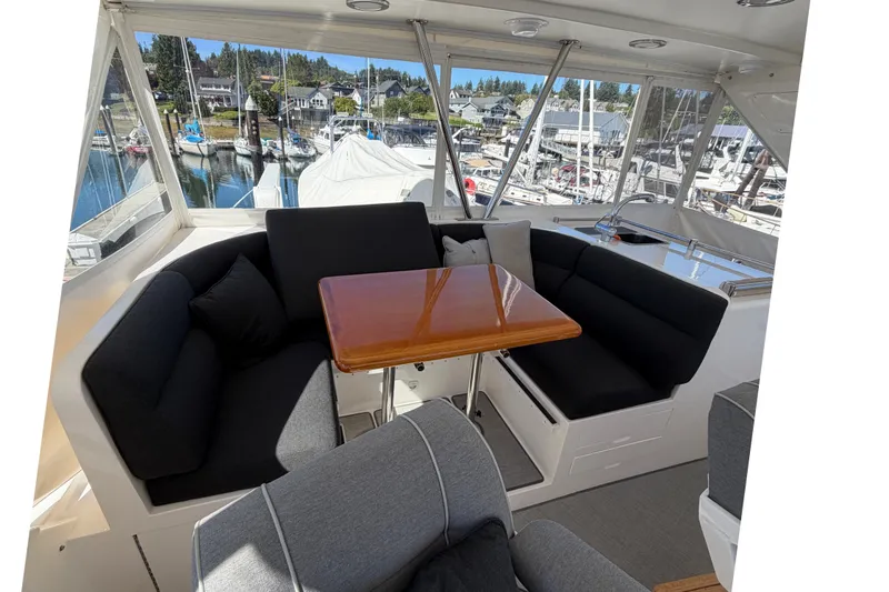 Slide: The Image of Luxurious 2004 Ocean Alexander 64 Pilothouse yacht interior with elegant seating and marina view. - 27