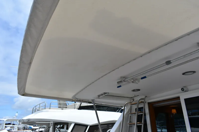 Slide: The Image of 2004 Ocean Alexander 64 Pilothouse yacht deck with ladder and canopy. - 10