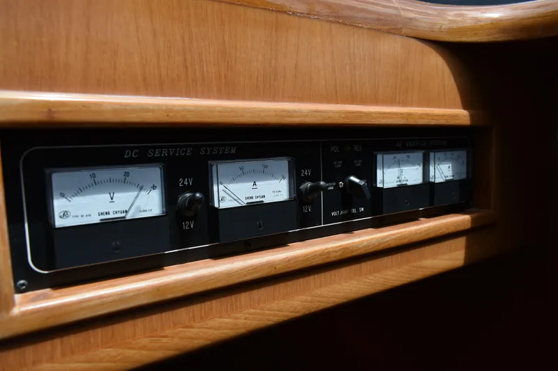 Slide: The Image of Control panel of a 2004 Ocean Alexander 64 Pilothouse yacht, featuring voltage and amperage gauges. - 40