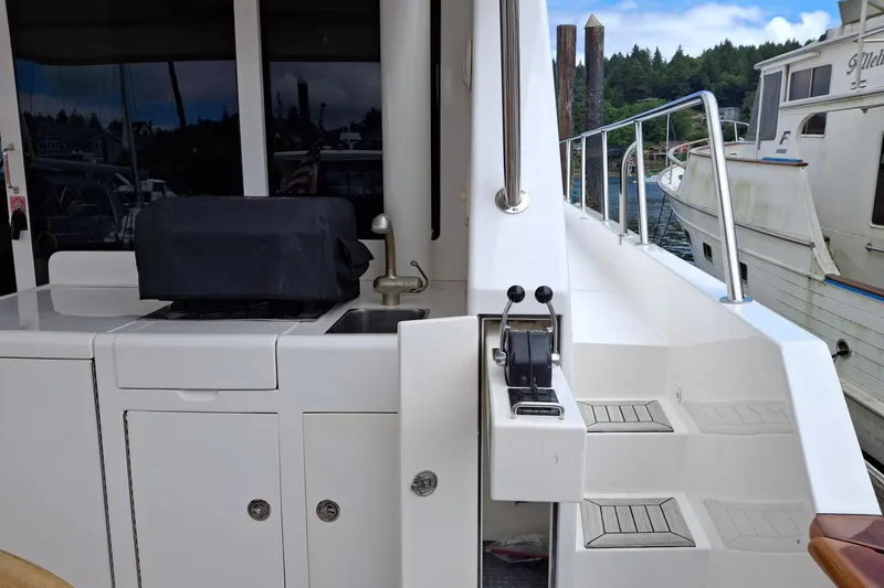 Slide: The Image of 2004 Ocean Alexander 64 Pilothouse yacht deck with outdoor kitchen and control panel. - 15