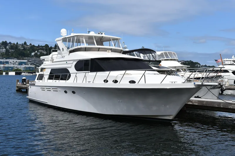 Slide: The Image of Luxury 2004 Ocean Alexander 64 Pilothouse yacht docked in a marina. - 90