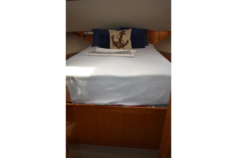 Slide: The Image of Luxurious bedroom in 2004 Ocean Alexander 64 Pilothouse yacht with nautical-themed decor. - 66