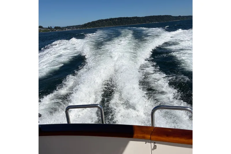Slide: The Image of Wake trail behind 2004 Ocean Alexander 64 Pilothouse on open water. - 99