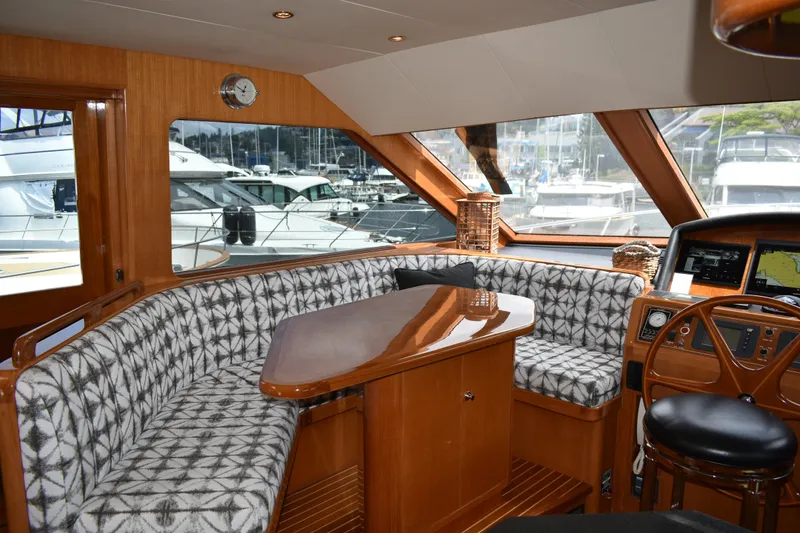 Slide: The Image of Luxurious interior of a 2004 Ocean Alexander 64 Pilothouse yacht with elegant seating and helm. - 32