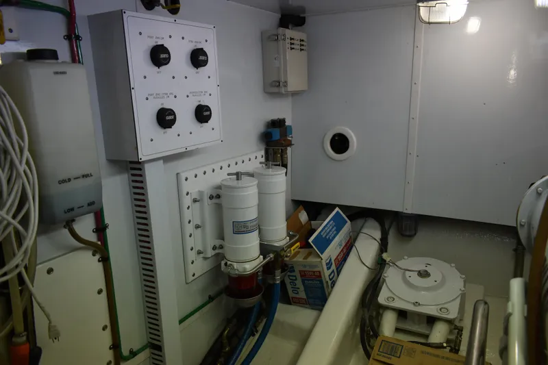 Slide: The Image of Engine room of 2004 Ocean Alexander 64 Pilothouse yacht with control panels and equipment. - 83
