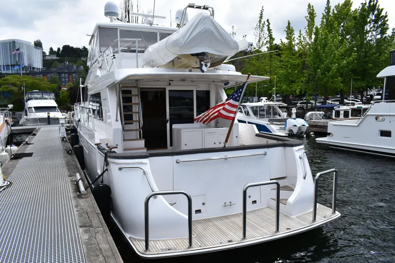 Slide: The Image of 2004 Ocean Alexander 64 Pilothouse yacht docked at marina with American flag. - 3