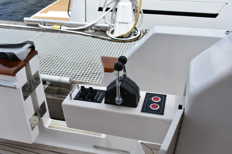 Slide: The Image of Control panel of a 2004 Ocean Alexander 64 Pilothouse yacht, featuring throttle levers and buttons. - 13