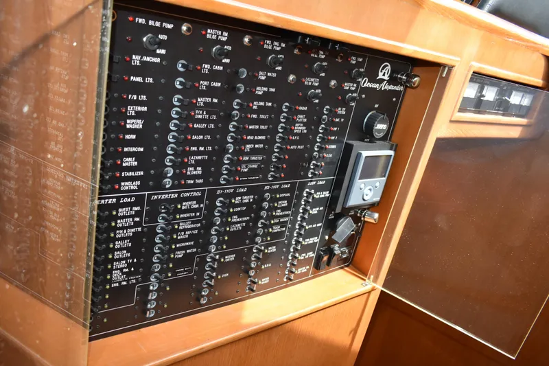 Slide: The Image of Control panel of a 2004 Ocean Alexander 64 Pilothouse yacht, featuring various switches and gauges. - 39