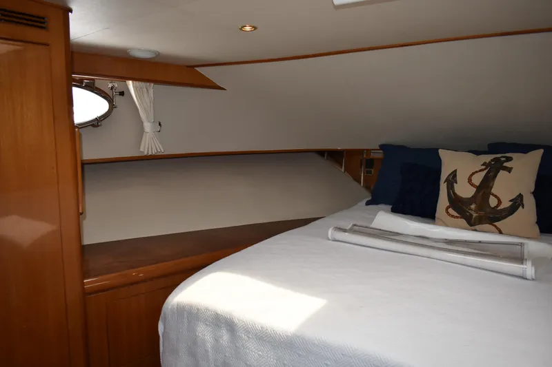 Slide: The Image of 2004 Ocean Alexander 64 Pilothouse cabin with cozy bed and nautical decor. - 69
