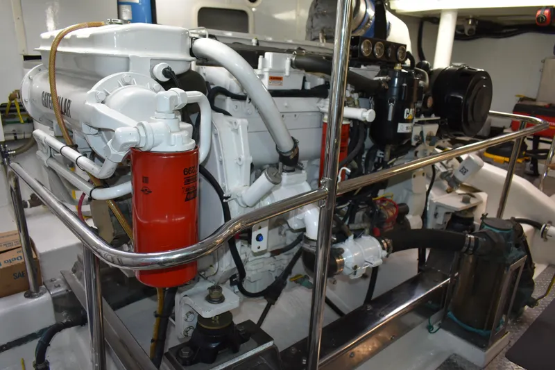 Slide: The Image of Engine room of 2004 Ocean Alexander 64 Pilothouse yacht, featuring Caterpillar machinery. - 82