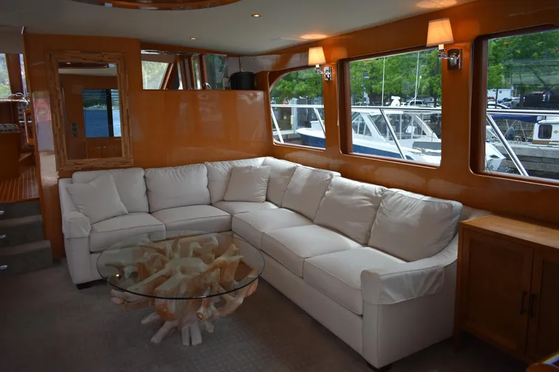Slide: The Image of Luxurious interior of 2004 Ocean Alexander 64 Pilothouse yacht with white sofa and glass table. - 45