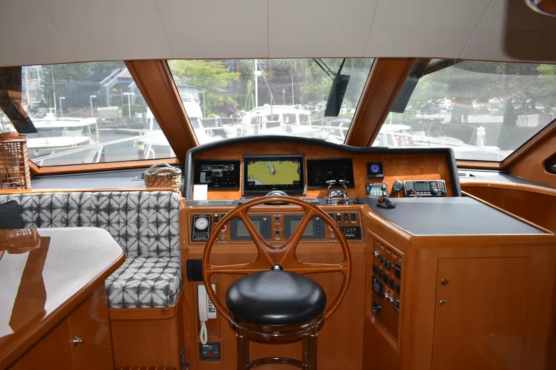 Slide: The Image of Pilothouse interior of 2004 Ocean Alexander 64, featuring navigation equipment and seating. - 35