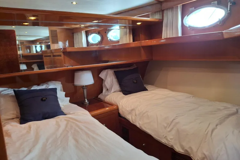 Slide: The Image of Luxurious twin cabin in 2004 Ocean Alexander 64 Pilothouse yacht with elegant wood finish. - 62