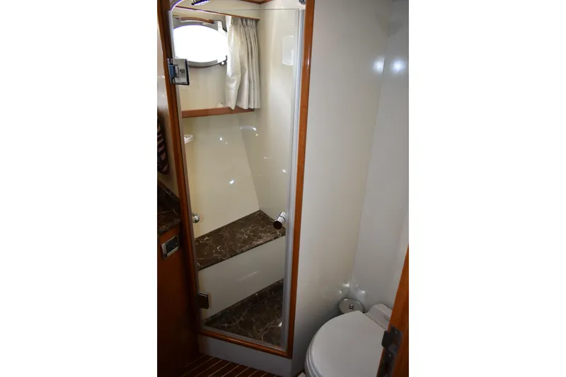 Slide: The Image of Bathroom interior of 2004 Ocean Alexander 64 Pilothouse yacht, featuring shower and toilet. - 65