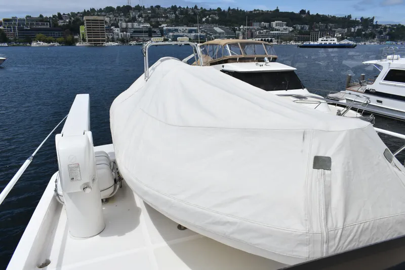 Slide: The Image of 2004 Ocean Alexander 64 Pilothouse yacht with covered equipment on deck, docked in a marina. - 29