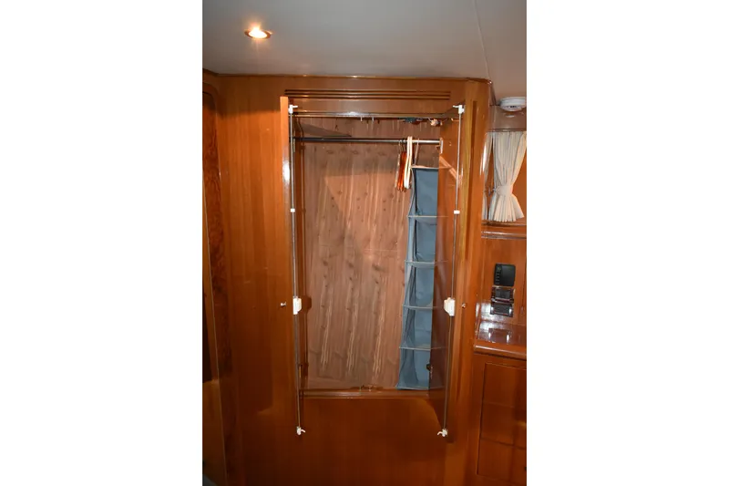 Slide: The Image of Wooden closet interior on 2004 Ocean Alexander 64 Pilothouse yacht. - 57