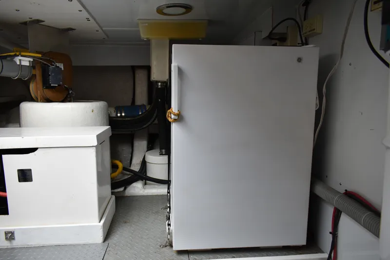 Slide: The Image of Engine room of 2004 Ocean Alexander 64 Pilothouse with equipment and storage. - 87