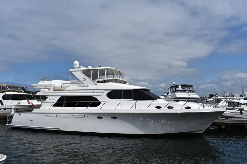 The Image of 2004 Ocean Alexander 64 Pilothouse yacht docked at marina under cloudy sky. - 0