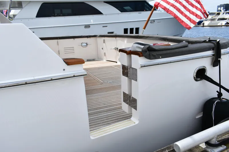 Slide: The Image of 2004 Ocean Alexander 64 Pilothouse yacht with American flag, docked at marina. - 6