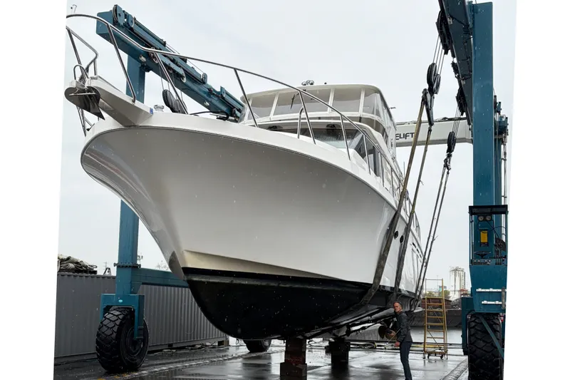Slide: The Image of 2004 Ocean Alexander 64 Pilothouse yacht in dry dock, supported by a boat lift. - 94