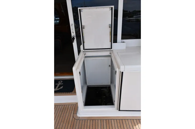 Slide: The Image of Open storage compartment on 2004 Ocean Alexander 64 Pilothouse yacht deck. - 72