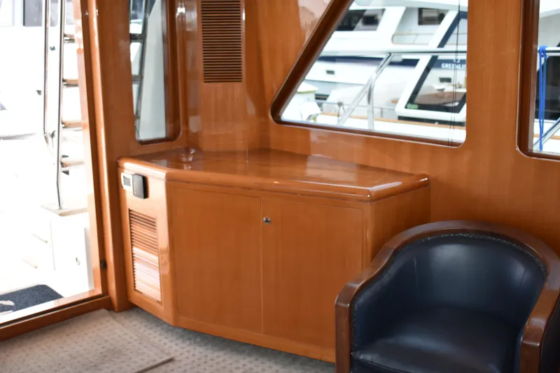 Slide: The Image of Interior of 2004 Ocean Alexander 64 Pilothouse with wooden cabinetry and leather chair. - 47