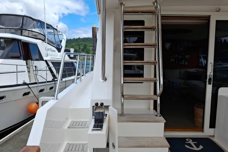 Slide: The Image of Ocean Alexander 64 Pilothouse yacht, 2004 model, featuring exterior stairs and deck view. - 12